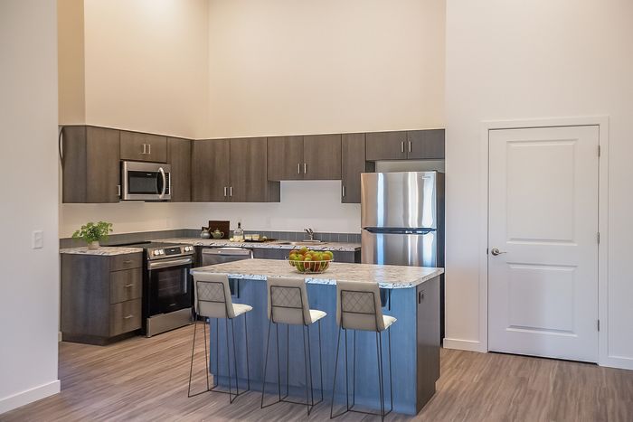 Staged kitchen with island at Pacific Ridge in Tigard, OR
