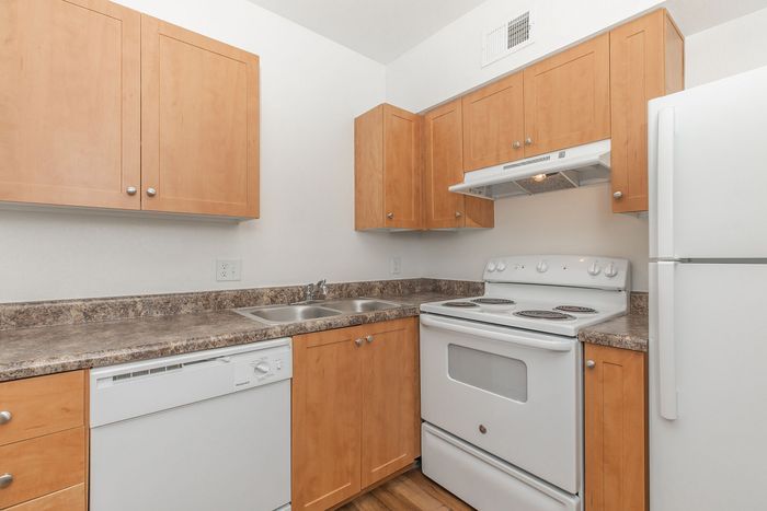 kitchen with white appliances and wood-like flooring