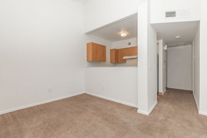 carpeted dining area and kitchen with breakfast bar