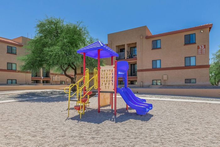 playground and three story apartment building in the background