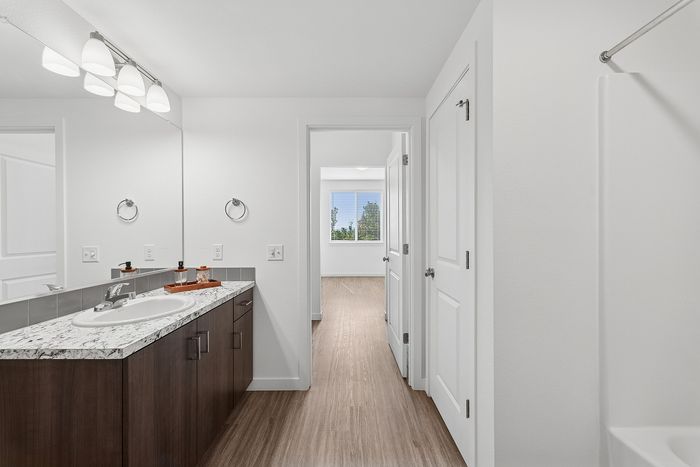 bathroom with vanity and tub shower combo