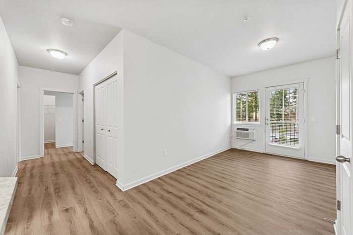 living room with hallway that has closets