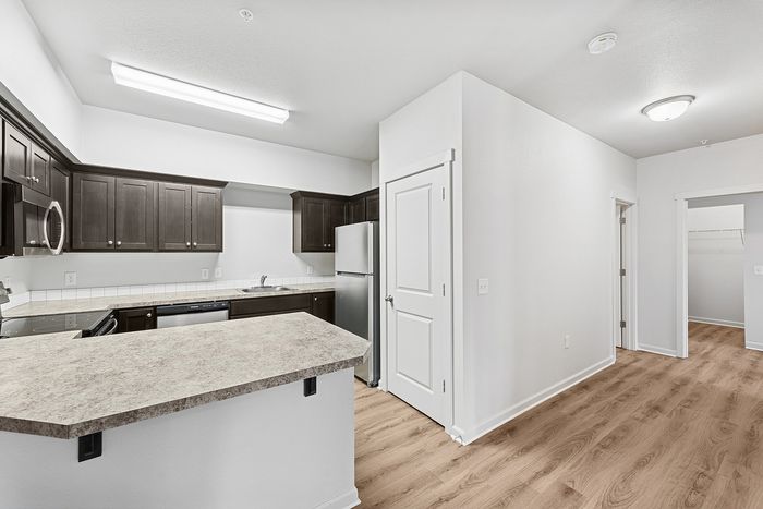 kitchen with stainless steel appliances and hallway
