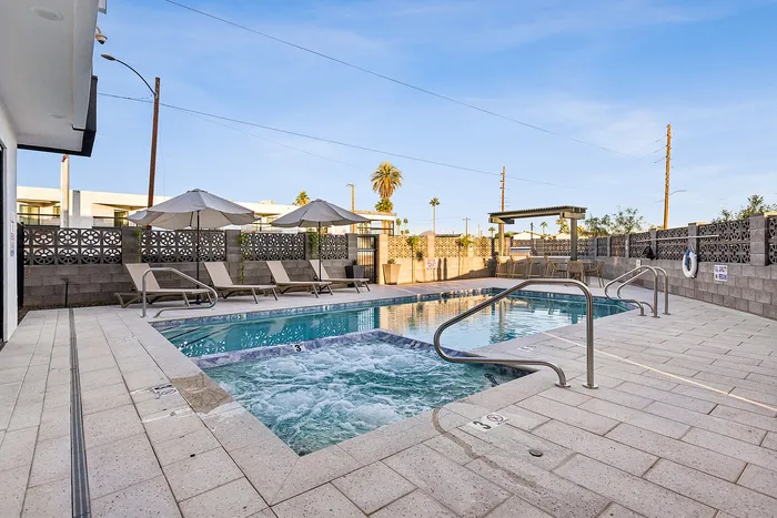 pool and hot tub with lounge area at asa apartments
