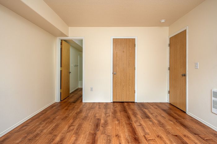 Bedroom with wooden floors.