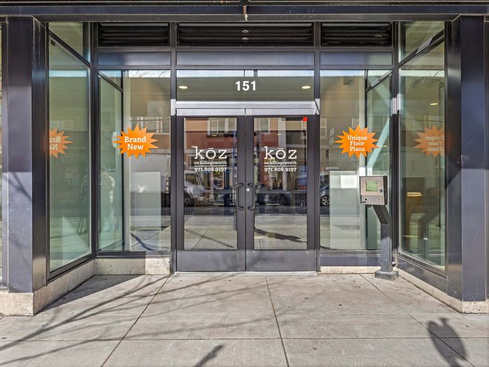 Main glass entrance to Koz on N. Killingsworth apartment community.