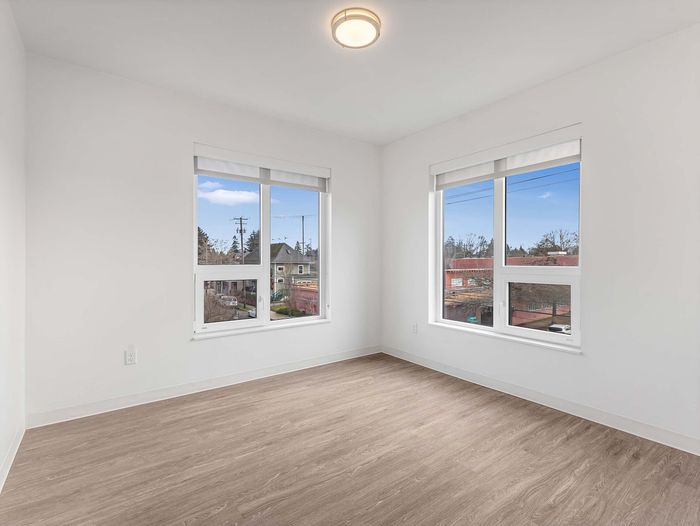 Sun-drenched bedroom with dual windows at Koz on N. Killingsworth.