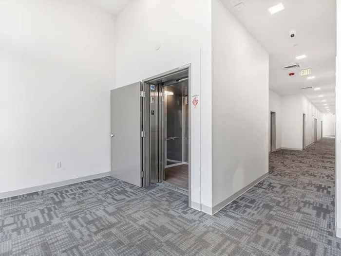 Modern elevator lobby with clean finishes at Koz on 4th apartments.