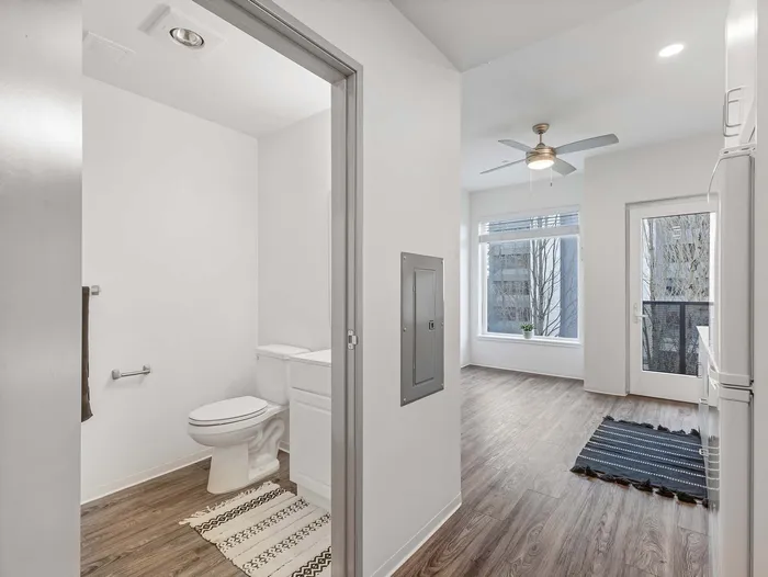 Modern studio apartment entryway and bathroom at Koz on 4th.
