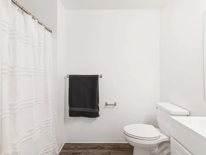 Clean, modern bathroom featuring a white shower and vanity at Koz on 4th.