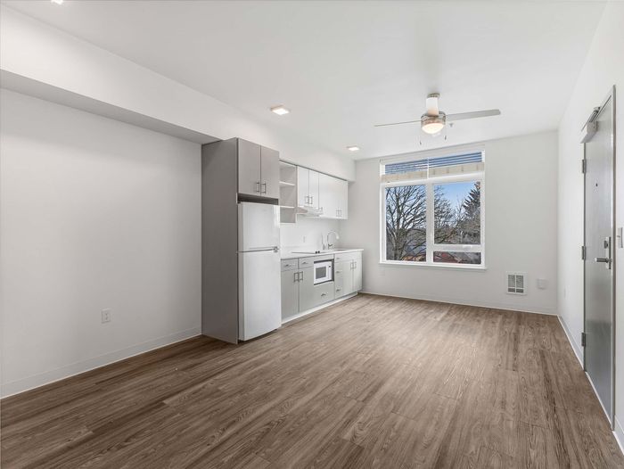 Modern studio apartment with ceiling fan at Koz on 13th.