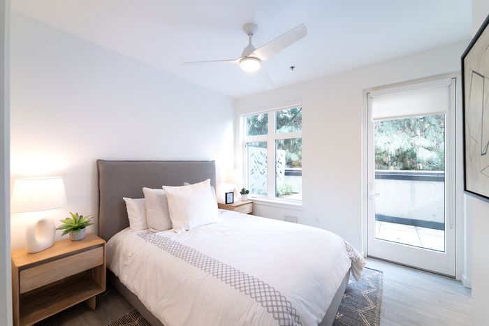 Bedroom with balcony and ceiling fan