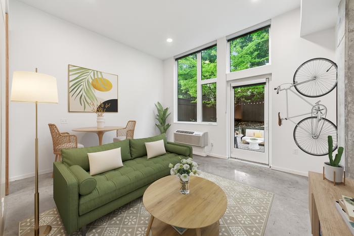artisan living room virtual staging with couch, bike rack and windows