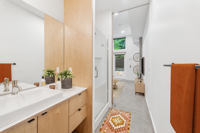 artisan bathroom showing glass walk-in shower and sink
