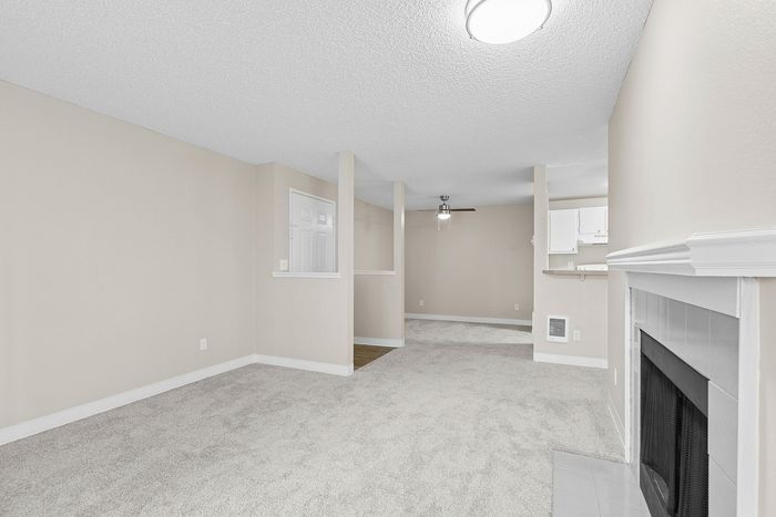 angle 3 of living room of C1 renovated floorplan at Timber Flats showing front door and dining room