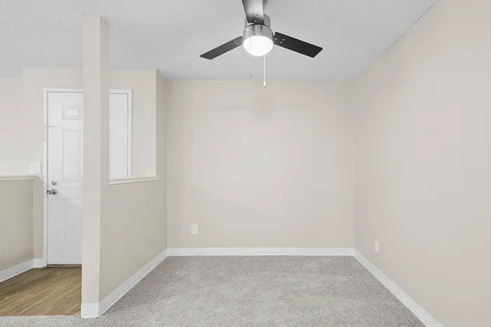 dining room of C1 renovated floorplan at Timber Flats with ceiling fan and carpet