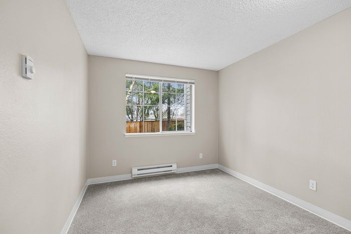 bedroom 1 in C1 renovated floorplan at Timber Flats window and carpet