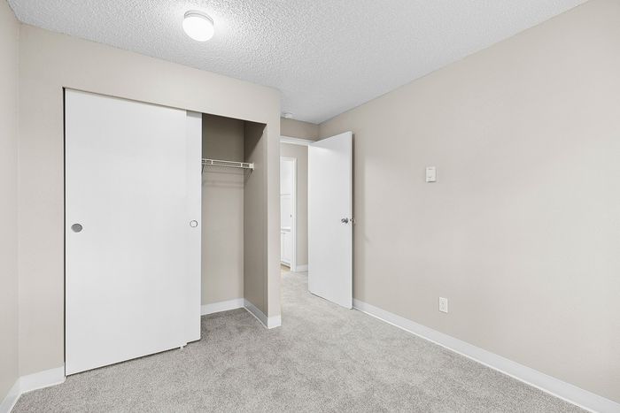 angle 2 of bedroom 1 in C1 renovated floorplan at Timber Flats closet view
