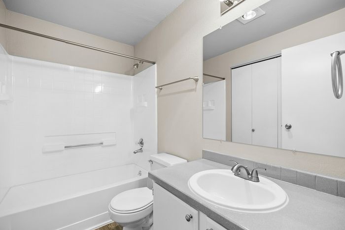 bathroom in C1 renovated floorplan at Timber Flats shower/tub toilet and sink grey countertops