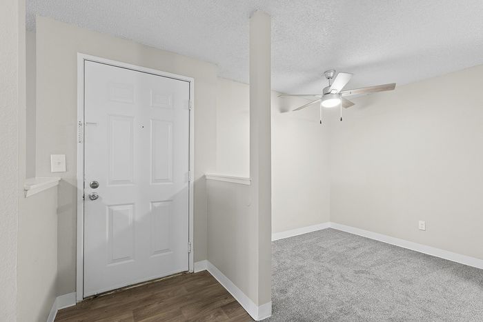 entryway in B1 renovated floorplan at Timber Flats with view of dining room with a ceiling fan