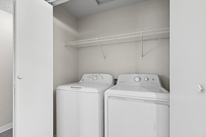 washer and dryer in B1 renovated floorplan at Timber Flats with shelving white