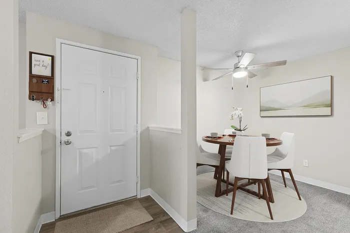 Virtually staged entryway and dining room at Timber Flats