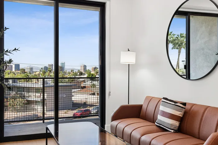 Living room at ASA with couch, mirror, and view outside
