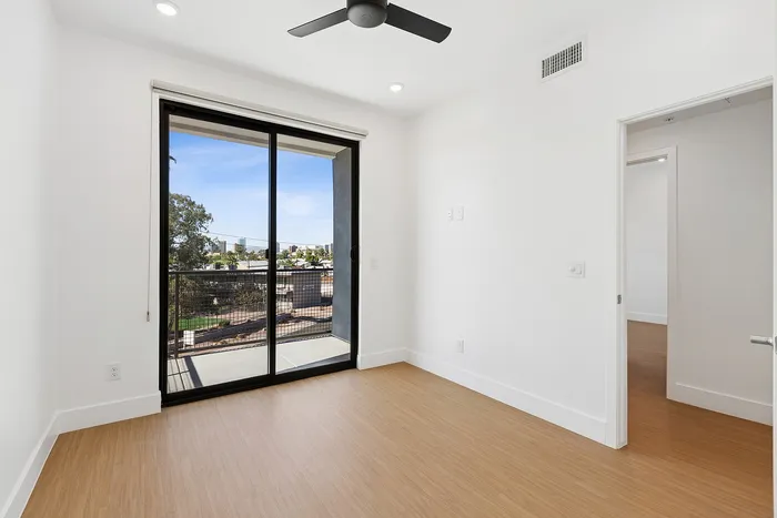 Unfurnished living room at ASA with a sliding glass door out to the patio