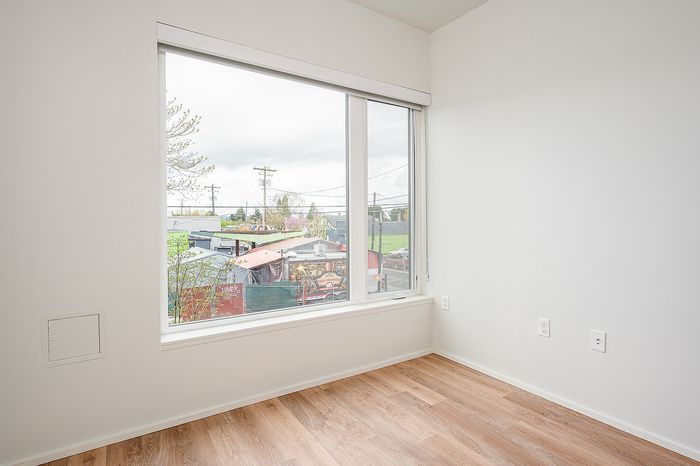 One Bedroom at Lyra Apartments - Living room with large window