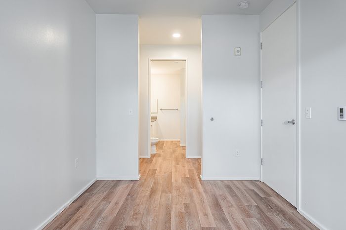 One Bedroom at Lyra Apartments - bedroom with walk-in closet and into the bathroom