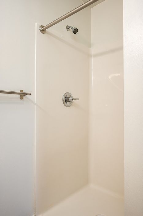One Bedroom at Lyra Apartments - Bathroom with walk-in shower and towel bar