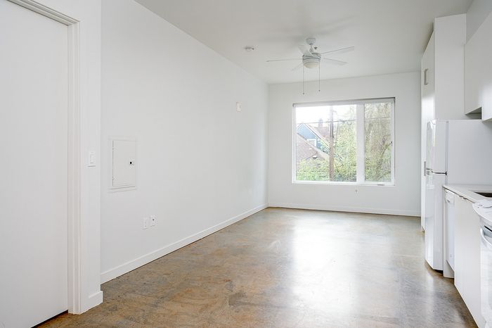 Cassi Apartments - kitchen into the living room with concrete floors
