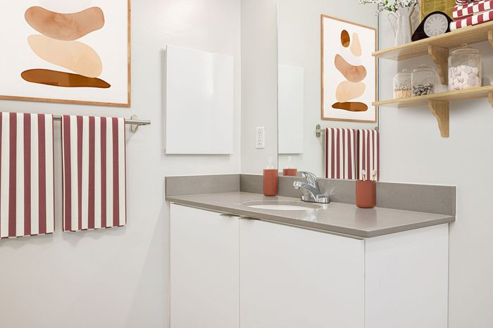 Virtually staged bathroom at Lyra with art, towels, and decor