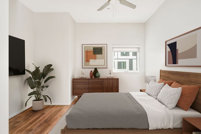 Virtually staged baedroom at Lyra with a bed, dresser, lamp, art