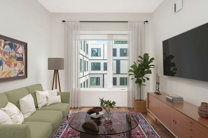 Virtually staged apartment at Lyra with a couch, tv, coffee table, rug and window