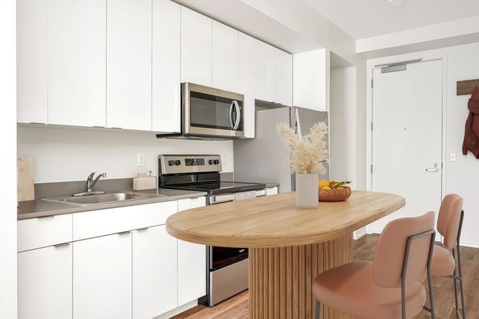 Virtually staged apartment at Lyra with a table, chairs and fruit bowl