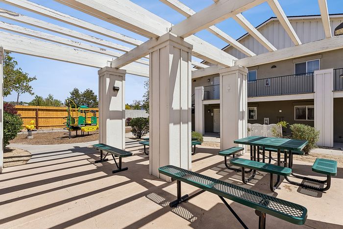 Community area with seatings, playground, and sunlight.