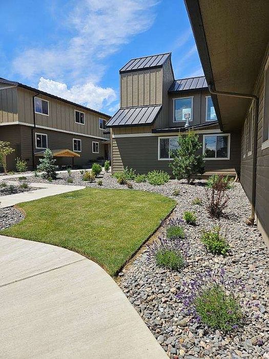 Lush green lawns and landscaped pathways at Lakeside Place.