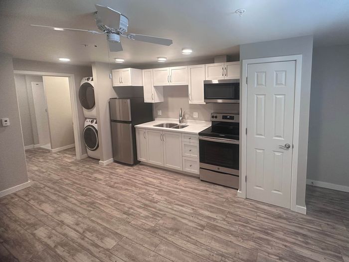 Open-concept kitchen with white cabinetry at Lakeside Place.