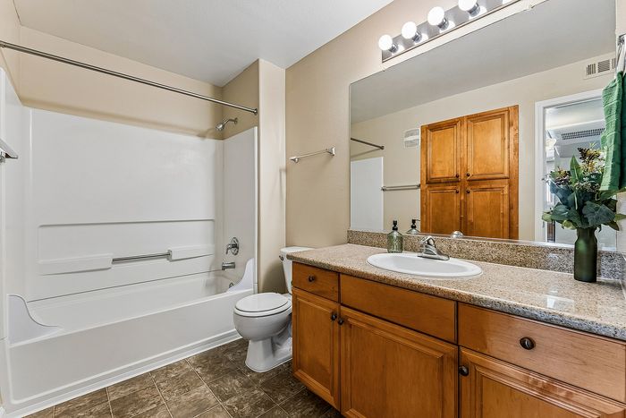 Bathroom with sink, shower, tub, and toilet.