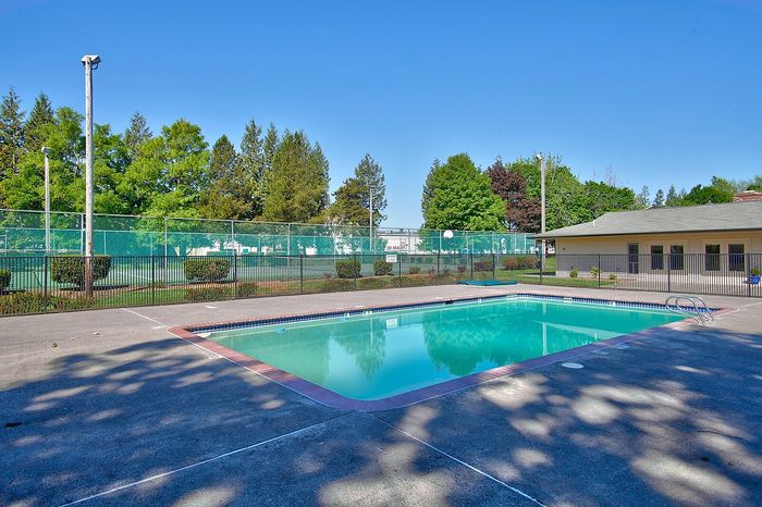 Refreshing outdoor swimming pool area with a secure perimeter fence at CAMPBELL PARK.