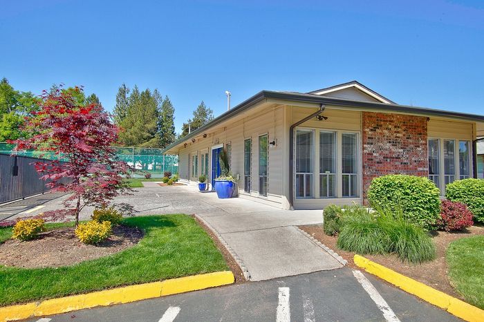 Manicured grass lawns surrounding a residential building entry at CAMPBELL PARK.