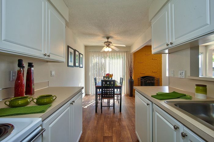 Galley-style kitchen showing clean appliances and modern finishes at CAMPBELL PARK.
