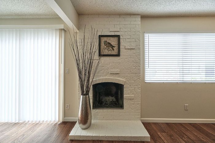 Bright apartment interior with a painted fireplace at CAMPBELL PARK.