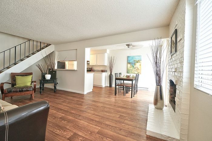 Open-concept main living area with faux-wood like flooring at CAMPBELL PARK.