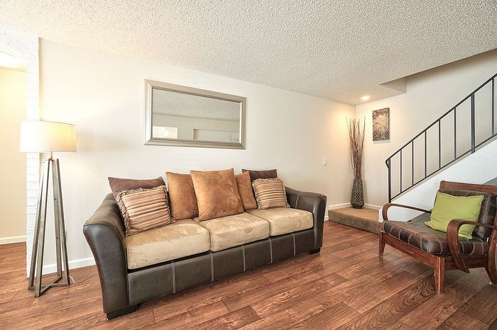 Furnished multi-level living room showing a staircase entry at CAMPBELL PARK.