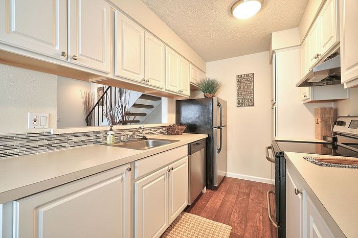 Long kitchen counter layout equipped with updated major appliances at CAMPBELL PARK.