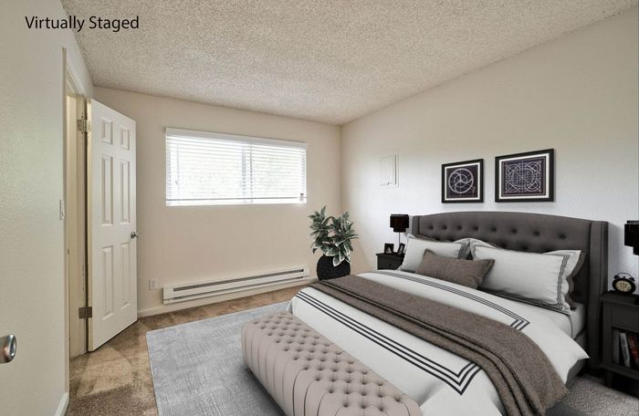 Virtually staged bedroom showcasing layout possibilities with a large bed at CAMPBELL PARK.