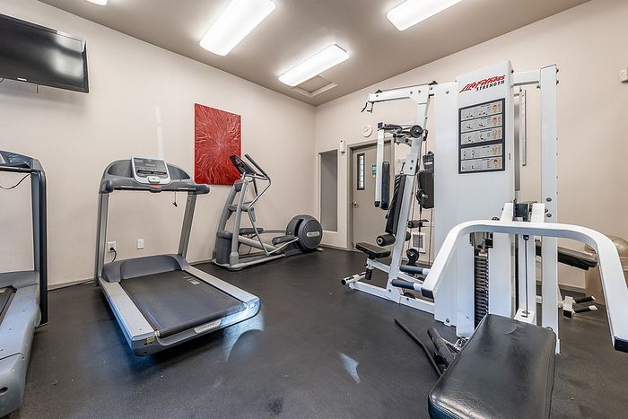 Clean exercise room displaying weight training machines at Berkeley Heights Apartment Homes.