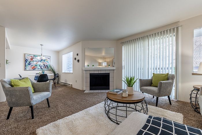 Spacious living area with plush carpets and modern furniture at Berkeley Heights Apartment Homes.